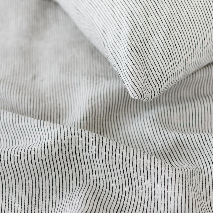 Foxtrot Home French Flax Linen styled in a bedroom with Pinstripe Pillowcases.