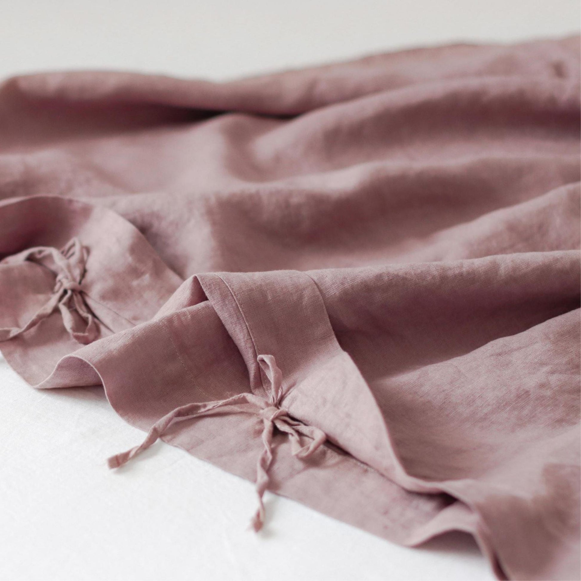 Foxtrot Home French Flax Linen styled in a baby's bedroom with Rosewood Pink Cot Duvet.
