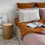 Foxtrot Home French Flax Linen styled in a bedroom with Rosewood Duvet, Grey Stripes and Pillowcases.