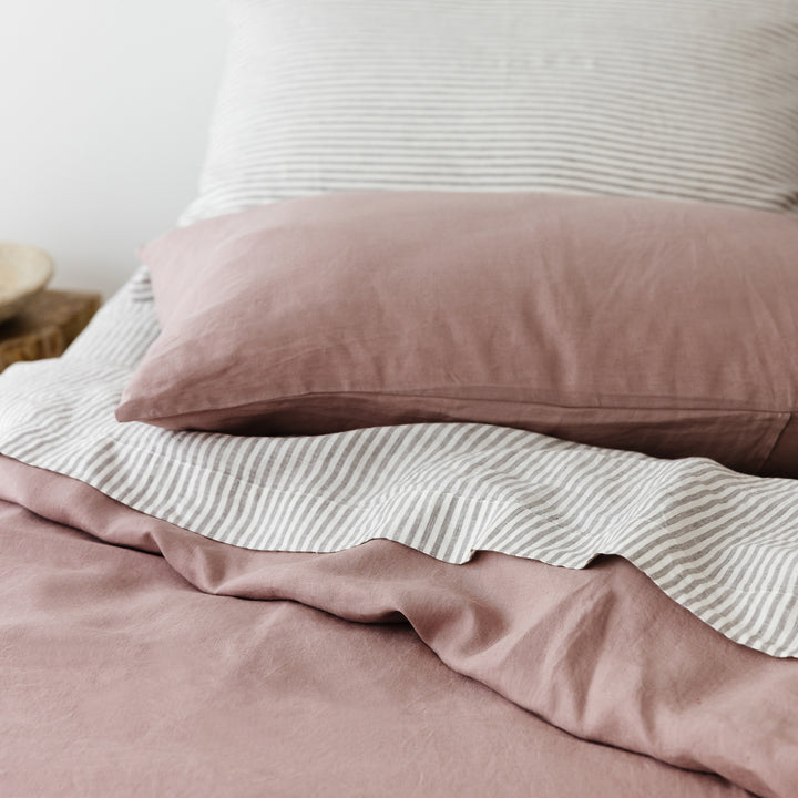 Foxtrot Home French Flax Linen styled in a bedroom with Rosewood Duvet, Grey Stripes and Pillowcases.
