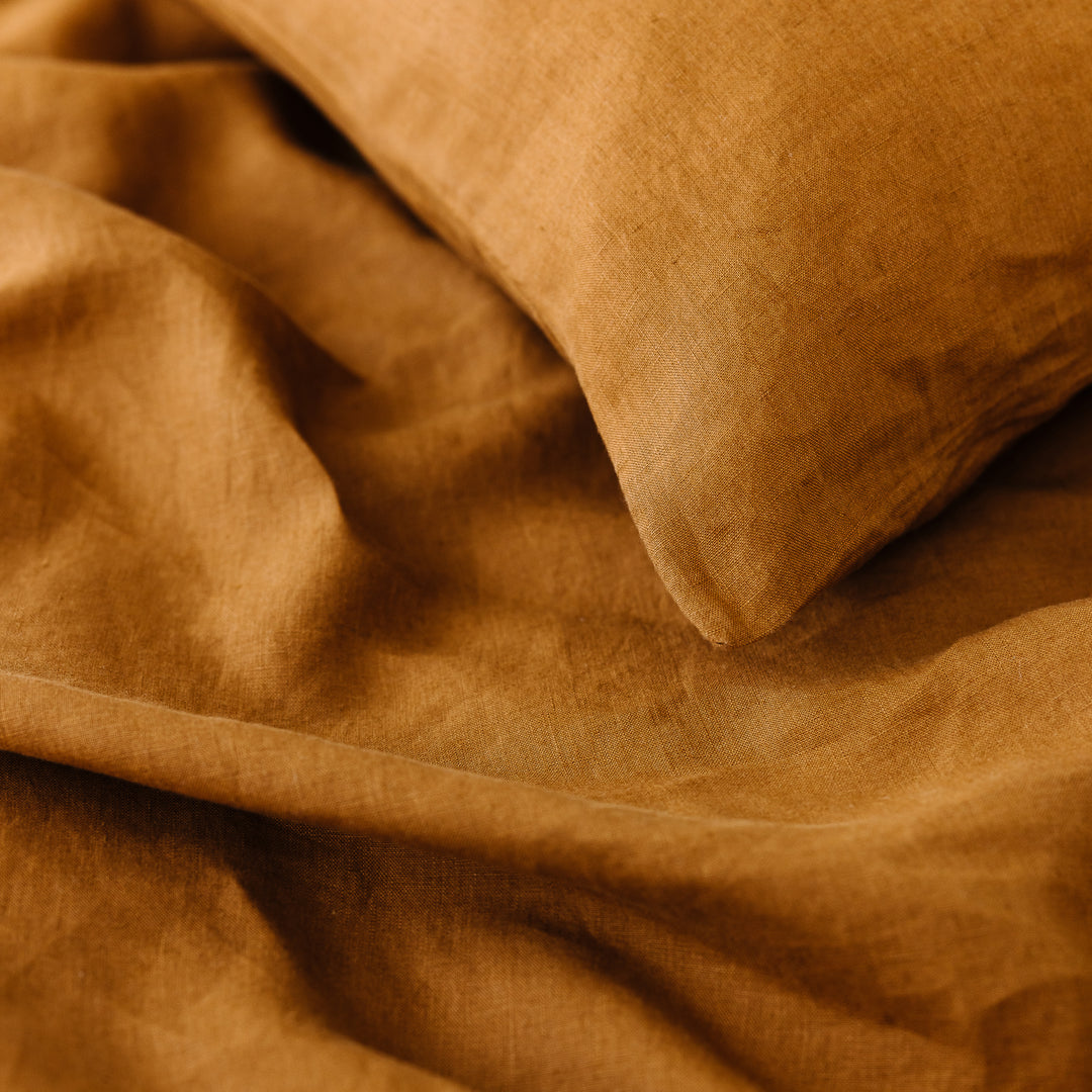 Foxtrot Home French Flax Linen styled in a bedroom with Tobacco Pillowcases.