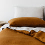 Foxtrot Home French Flax Linen styled in a bedroom with Tobacco Pillowcases.