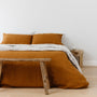 Foxtrot Home French Flax Linen styled in a bedroom with Tobacco Pillowcases.
