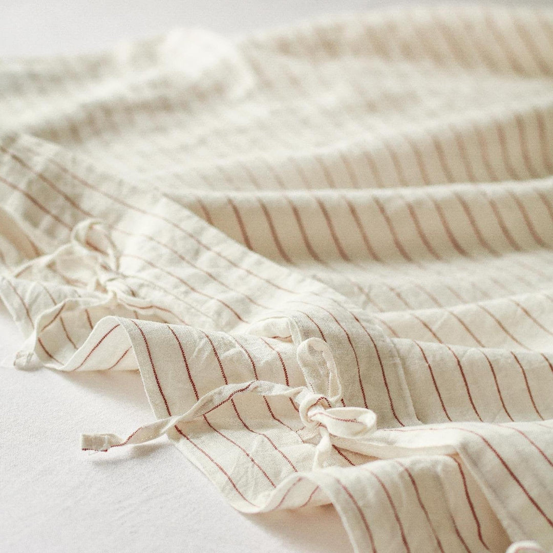 Foxtrot Home French Flax Linen styled in a baby's bedroom with a Tobacco Stripes Cot Duvet.
