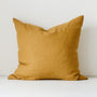 Foxtrot Home French Flax Linen styled in a bedroom with Ginger Honey Cushion Cover.