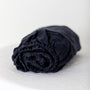 Foxtrot Home French Flax Linen styled in a baby's bedroom with Midnight Blue Cot Sheet and Bassinet Sheets.