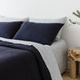 Foxtrot Home French Flax Linen styled in a bedroom with Midnight Blue Duvet.
