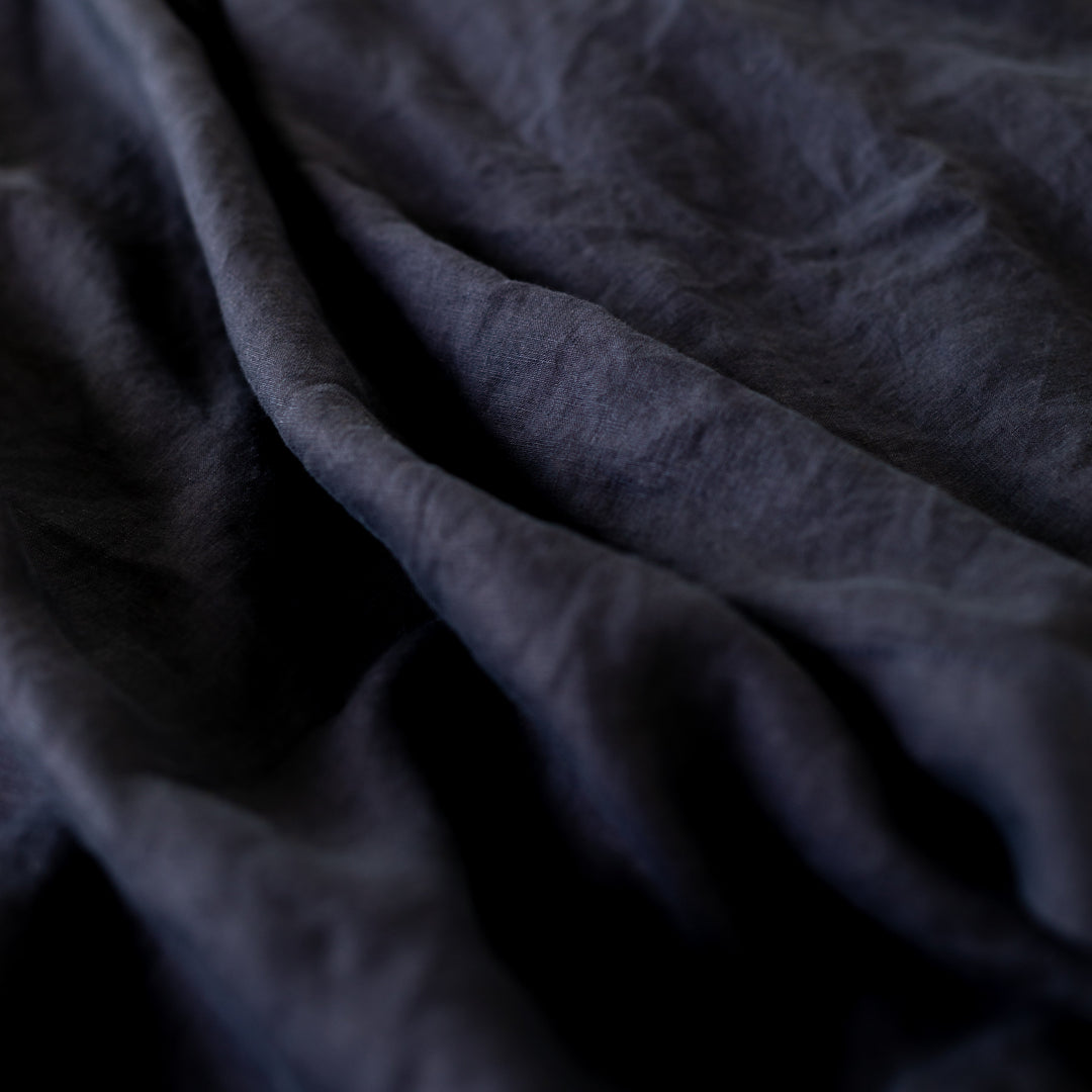 Foxtrot Home French Flax Linen styled in a bedroom with Midnight Blue Duvet.