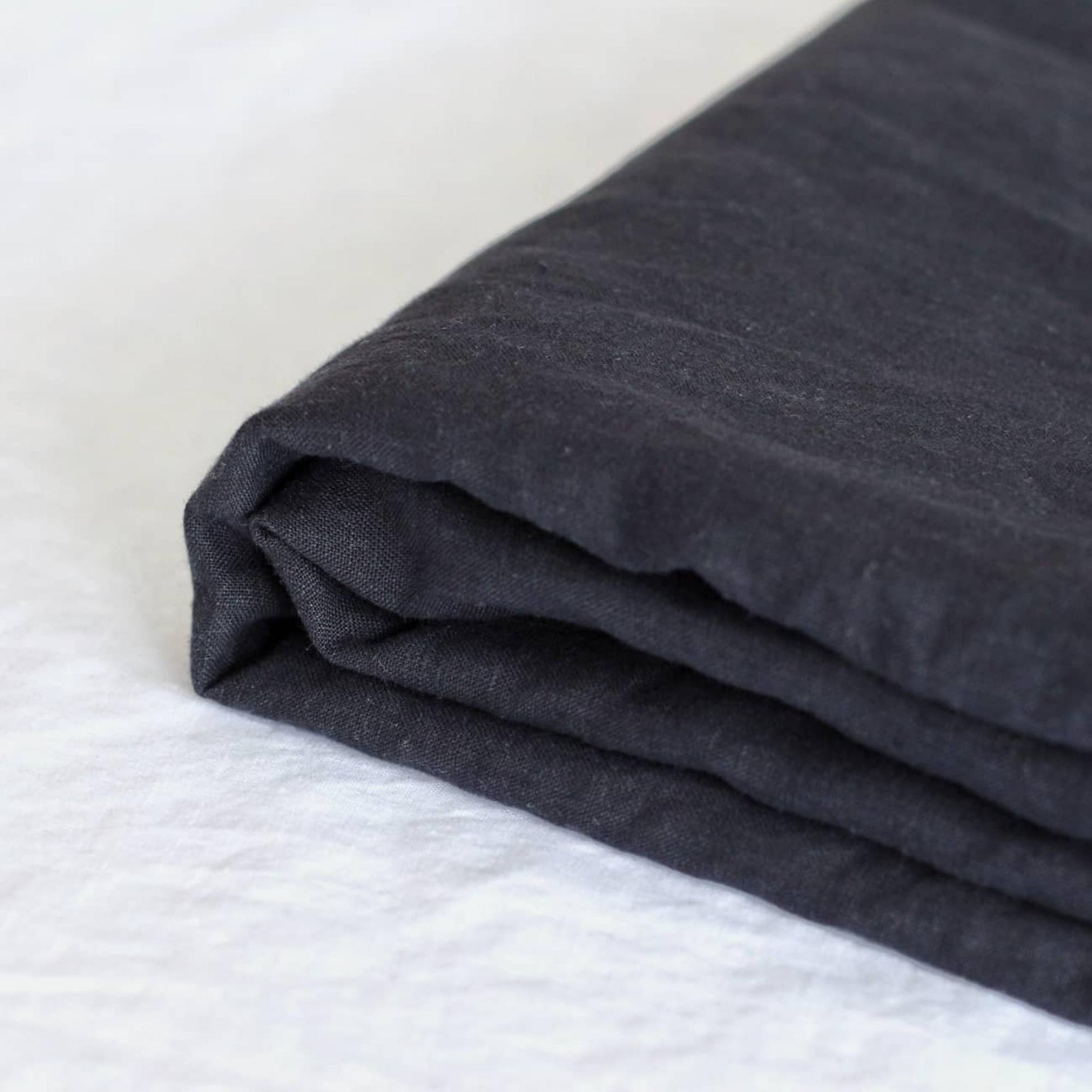 Foxtrot Home French Flax Linen styled in a bedroom with Midnight Blue Fitted Sheet.