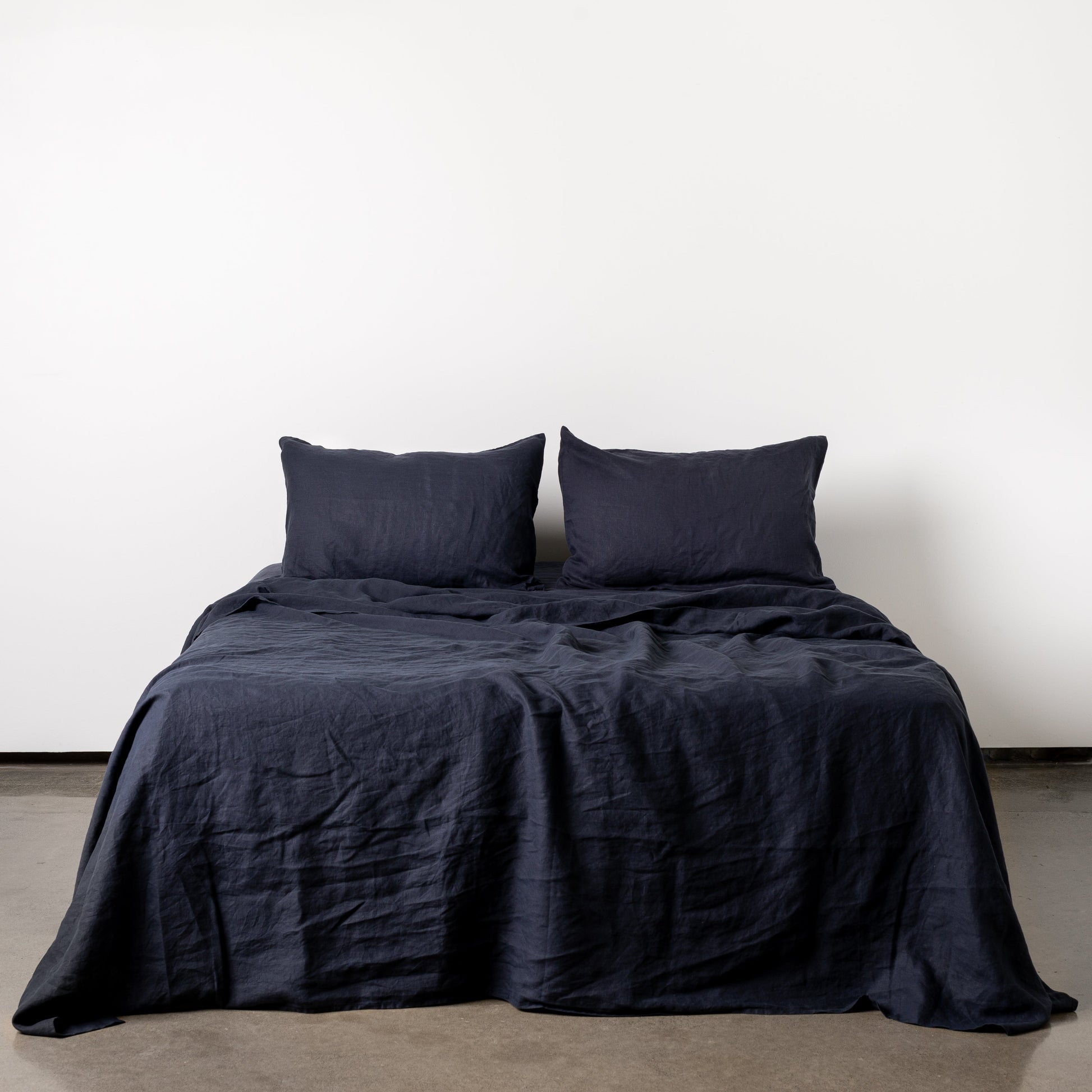 Foxtrot Home French Flax Linen styled in a bedroom with Midnight Blue Fitted Sheet.