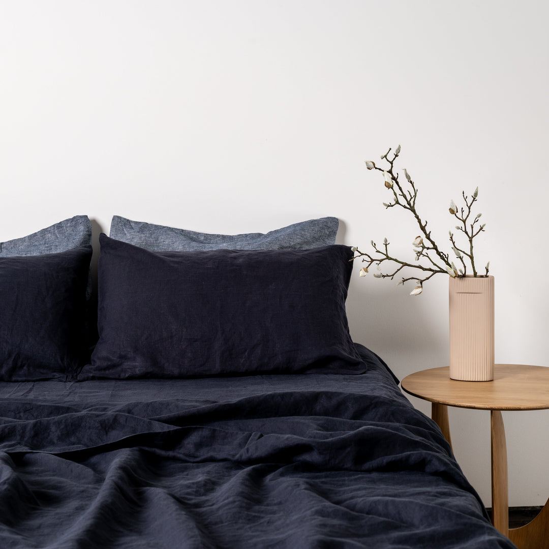 Foxtrot Home French Flax Linen styled in a bedroom with Midnight Blue Flat Sheet.