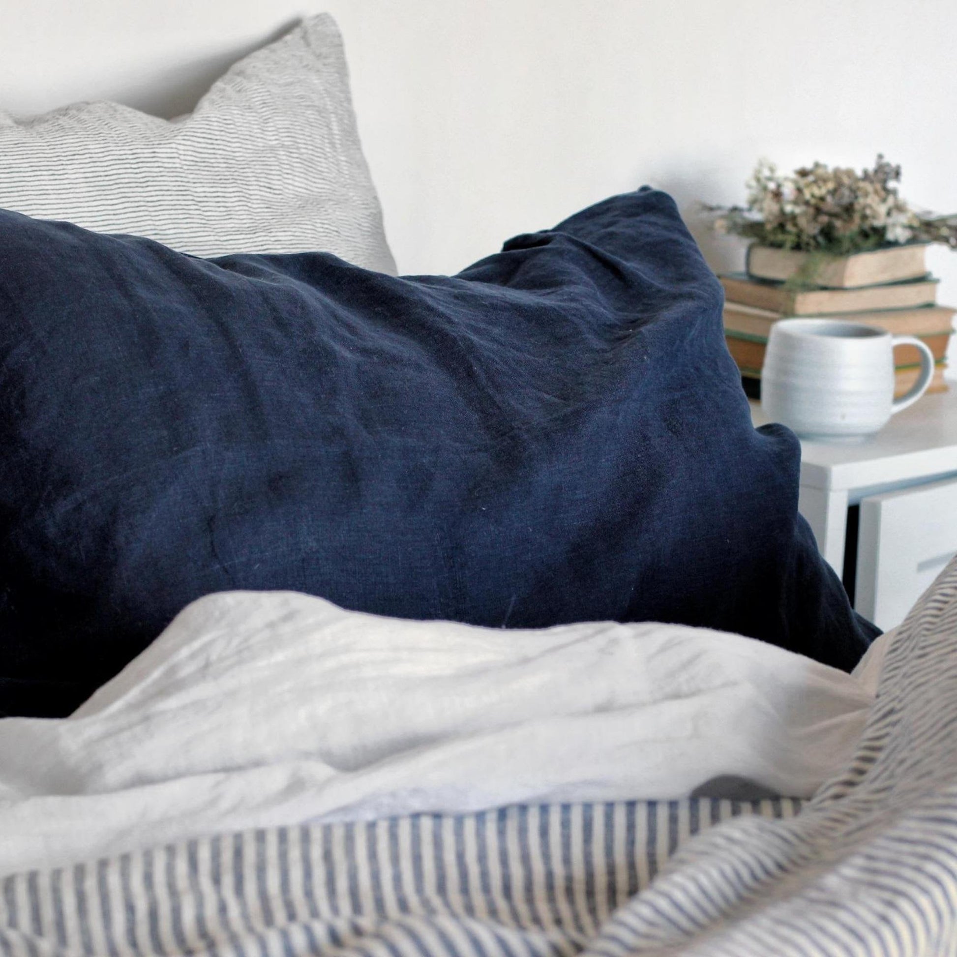 Foxtrot Home French Flax Linen styled in a bedroom with Midnight Blue Pillowcases.