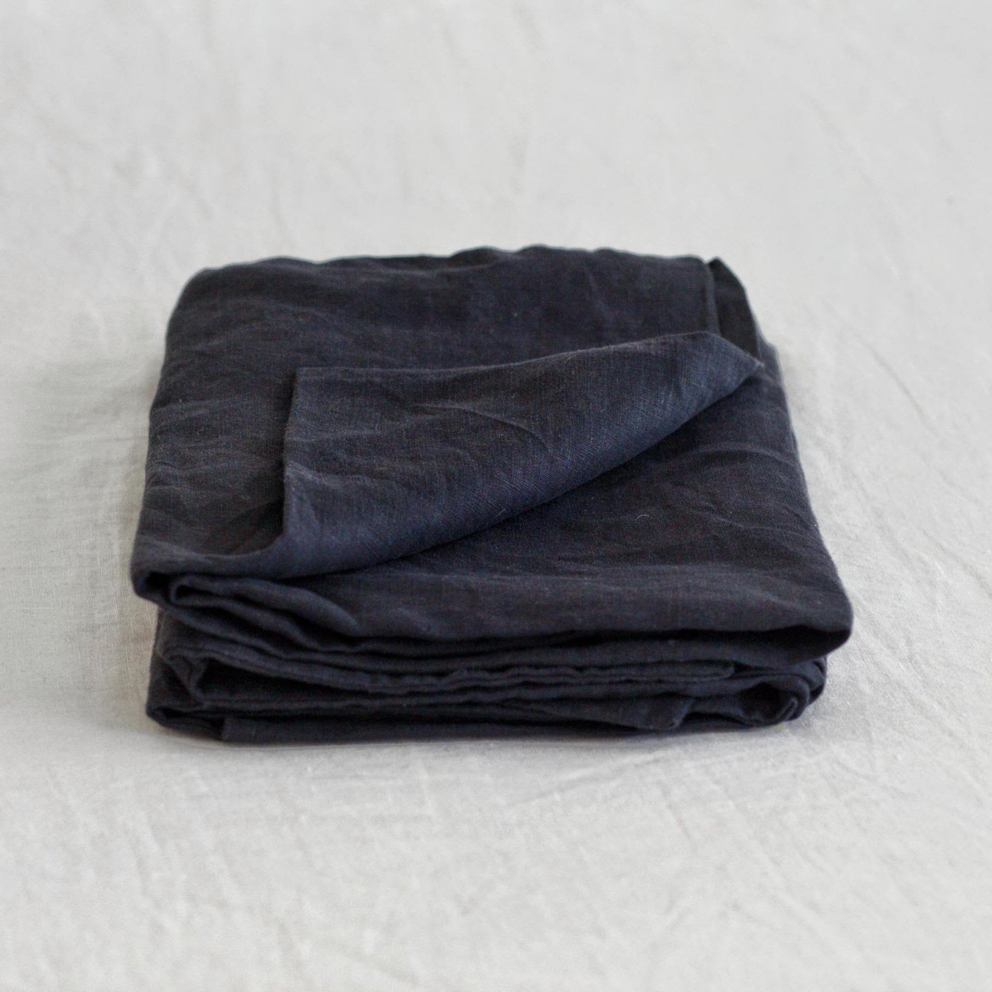Foxtrot Home French Flax Linen styled in a bedroom with Midnight Blue Pillowcases.