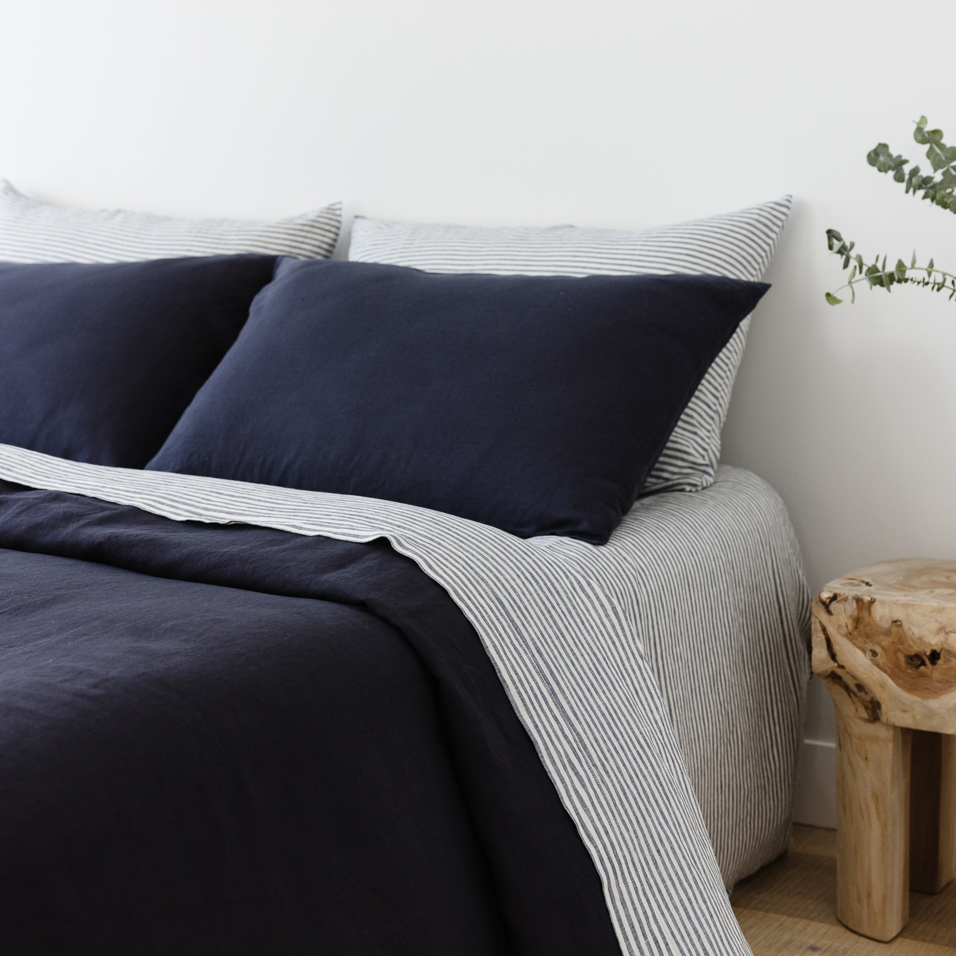 Foxtrot Home French Flax Linen styled in a bedroom with Midnight Blue Pillowcases.