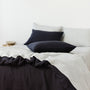 Foxtrot Home French Flax Linen styled in a bedroom with Midnight Blue Pillowcases.