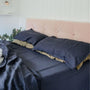 Foxtrot Home French Flax Linen styled in a bedroom with Midnight Blue Sheets Sets.