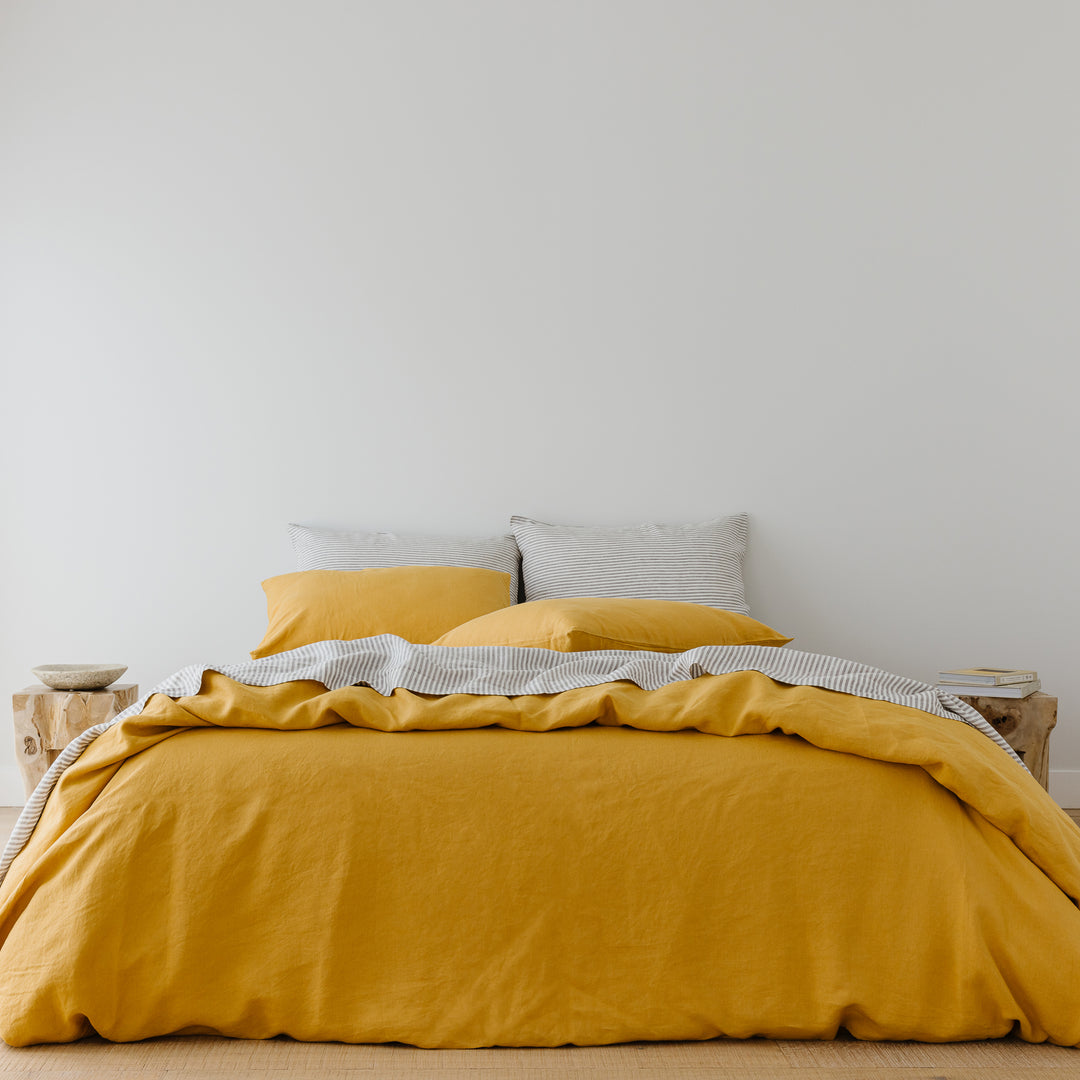 Foxtrot Home French Flax Linen styled in a bedroom with Mustard Yellow Duvet.