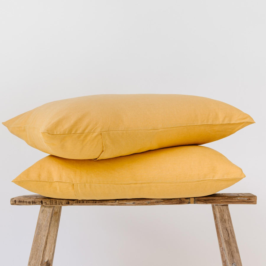 Foxtrot Home French Flax Linen styled in a bedroom with Mustard Yellow Pillowcases.