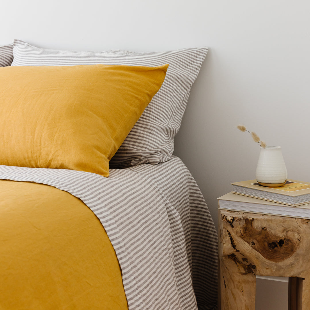 Foxtrot Home French Flax Linen styled in a bedroom with Mustard Yellow Pillowcases.