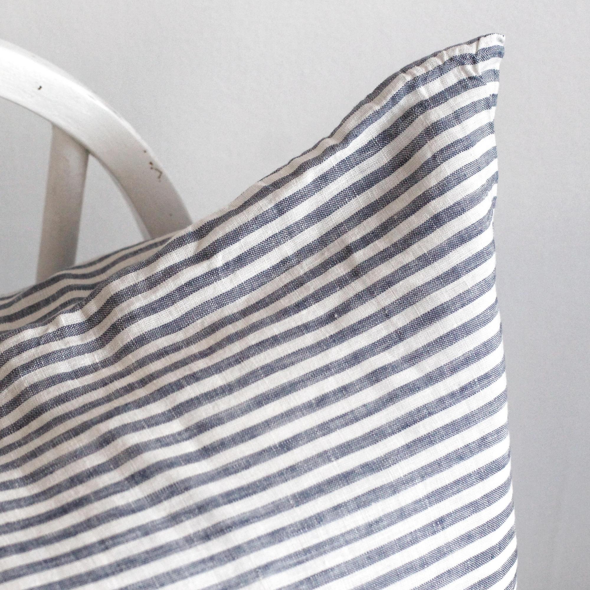 Foxtrot Home French Flax Linen styled in a bedroom with Navy Stripes Cushion Cover.