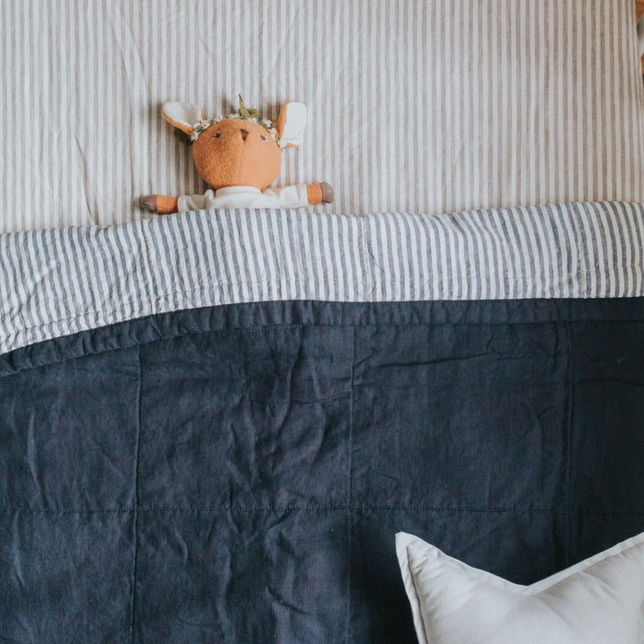 Foxtrot Home French Flax Linen styled in a bedroom with Navy & Blue Stripes Quilt.