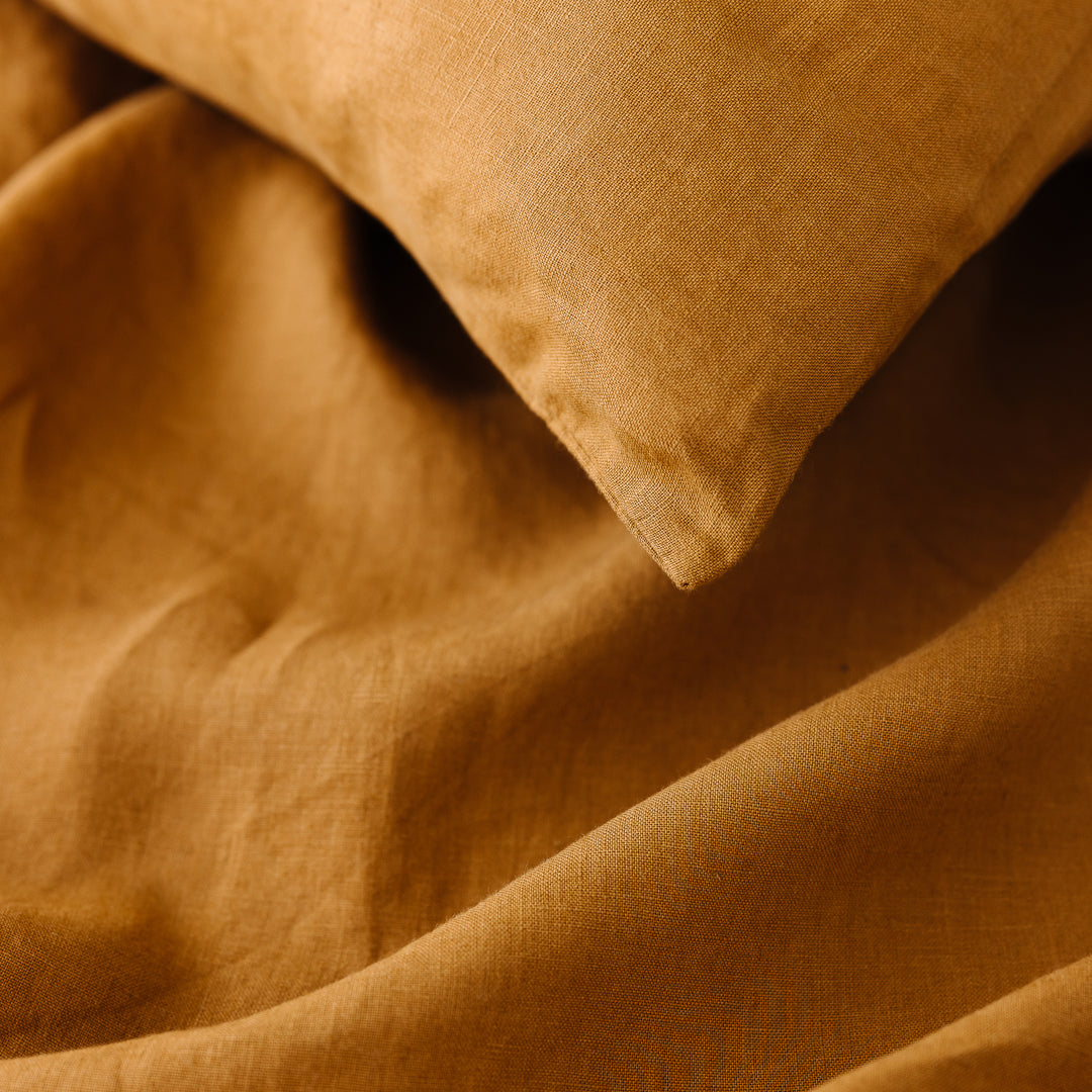 Foxtrot Home French Flax Linen styled in a bedroom with Ochre Fitted Sheet.
