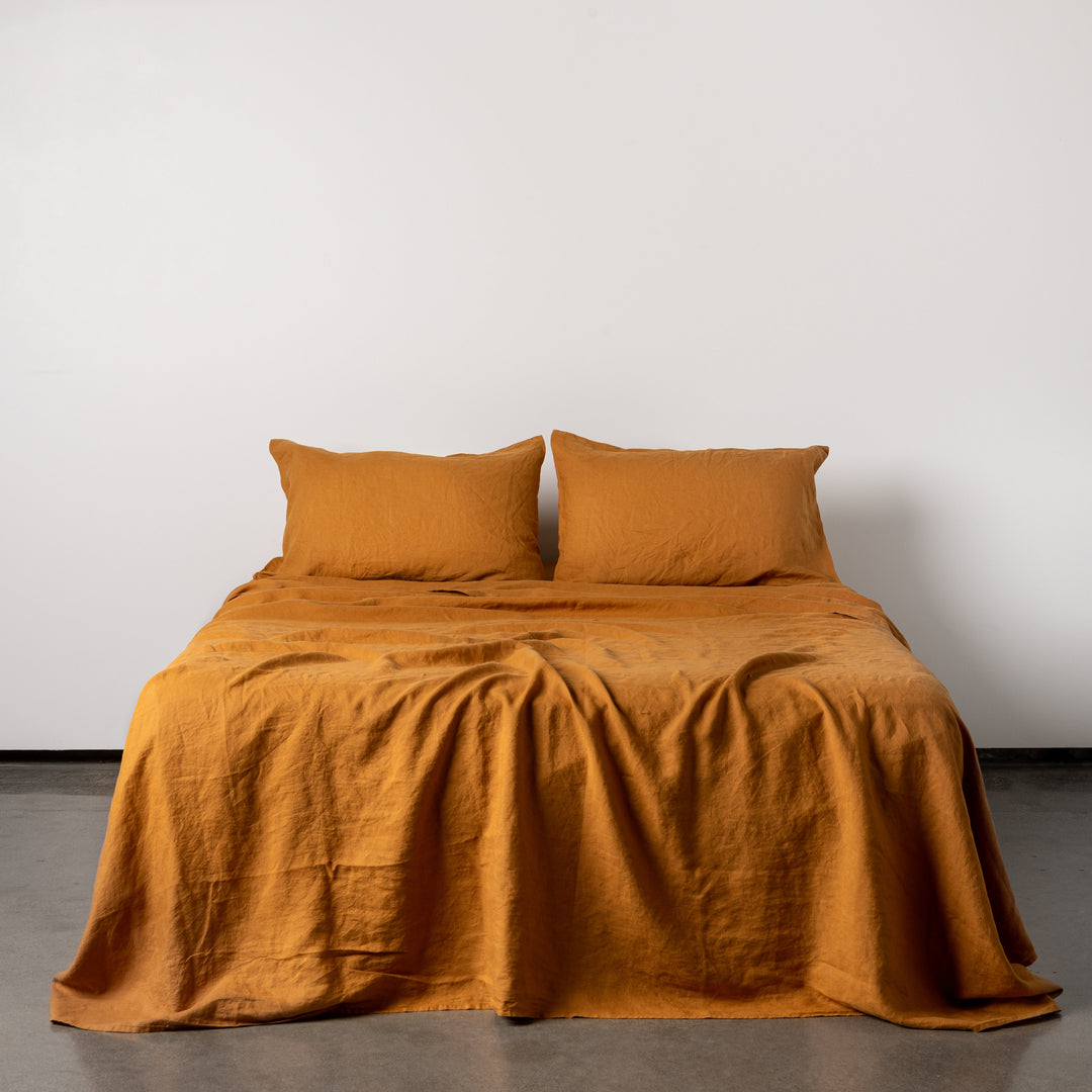 Foxtrot Home French Flax Linen styled in a bedroom with Ochre Flat Sheet.
