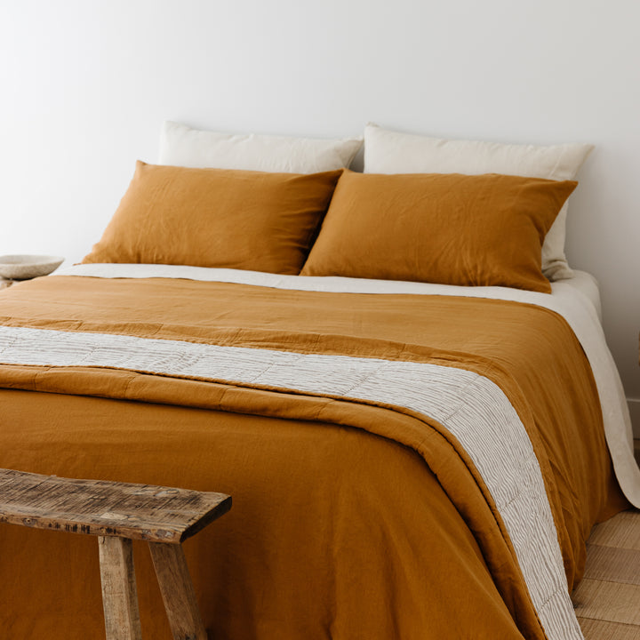 Foxtrot Home French Flax Linen styled in a bedroom with Ochre Pillowcases.