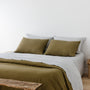 Foxtrot Home French Flax Linen styled in a bedroom with Olive Green Duvet, Navy Blue Sheets Set and Pillowcases.