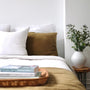 Foxtrot Home French Flax Linen styled in a bedroom with Olive Green Duvet, Navy Blue Sheets Set and Pillowcases.