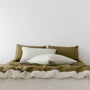 Foxtrot Home French Flax Linen styled in a bedroom with Olive Green Fitted Sheet.
