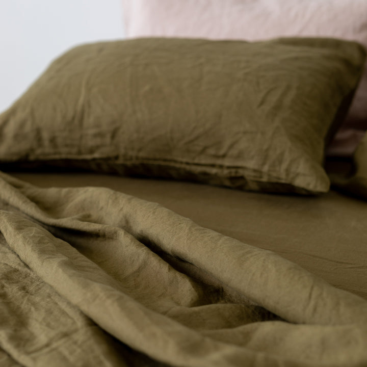 Foxtrot Home French Flax Linen styled in a bedroom with Olive Green Fitted Sheet.