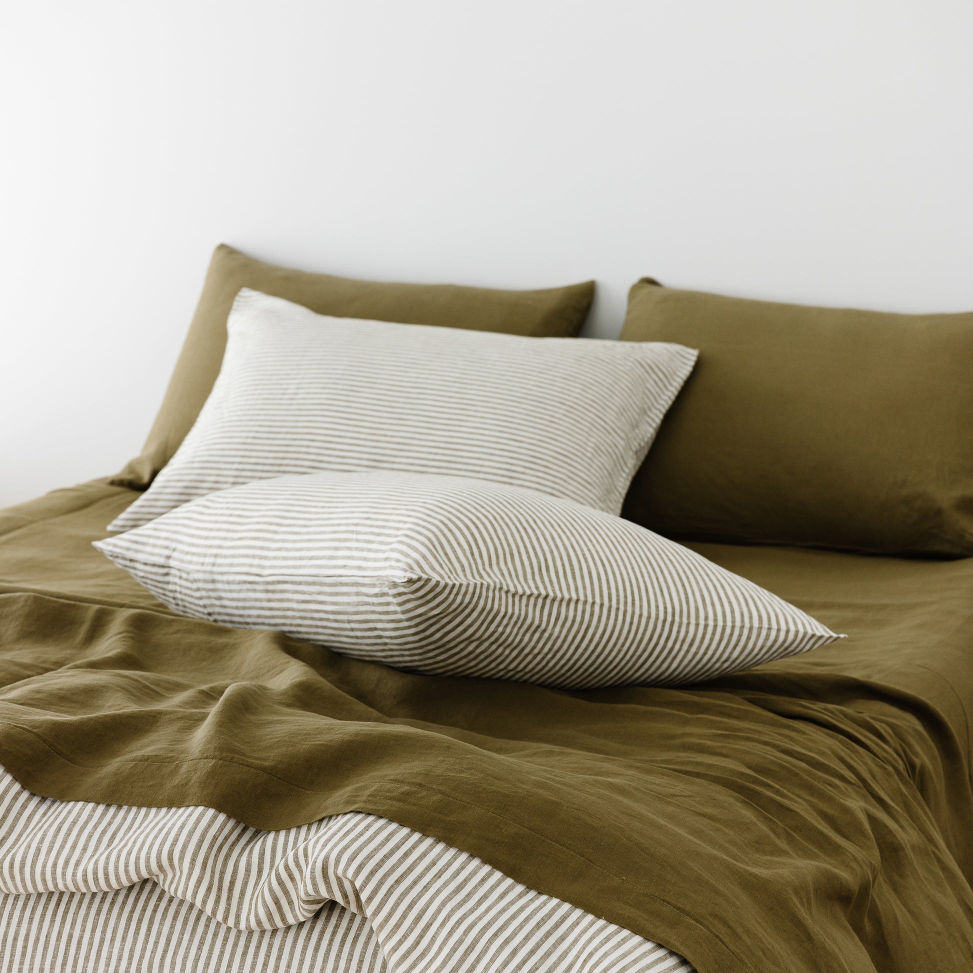 Foxtrot Home French Flax Linen styled in a bedroom with Olive Green Fitted Sheet.