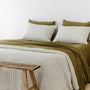 Foxtrot Home French Flax Linen styled in a bedroom with Olive Stripes Duvet, Olive Green Sheets Set and Pillowcases.