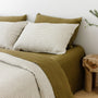 Foxtrot Home French Flax Linen styled in a bedroom with Olive Stripes Duvet, Olive Green Sheets Set and Pillowcases.