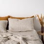 Foxtrot Home French Flax Linen styled in a bedroom with Olive Green Stripes Fitted Sheet.