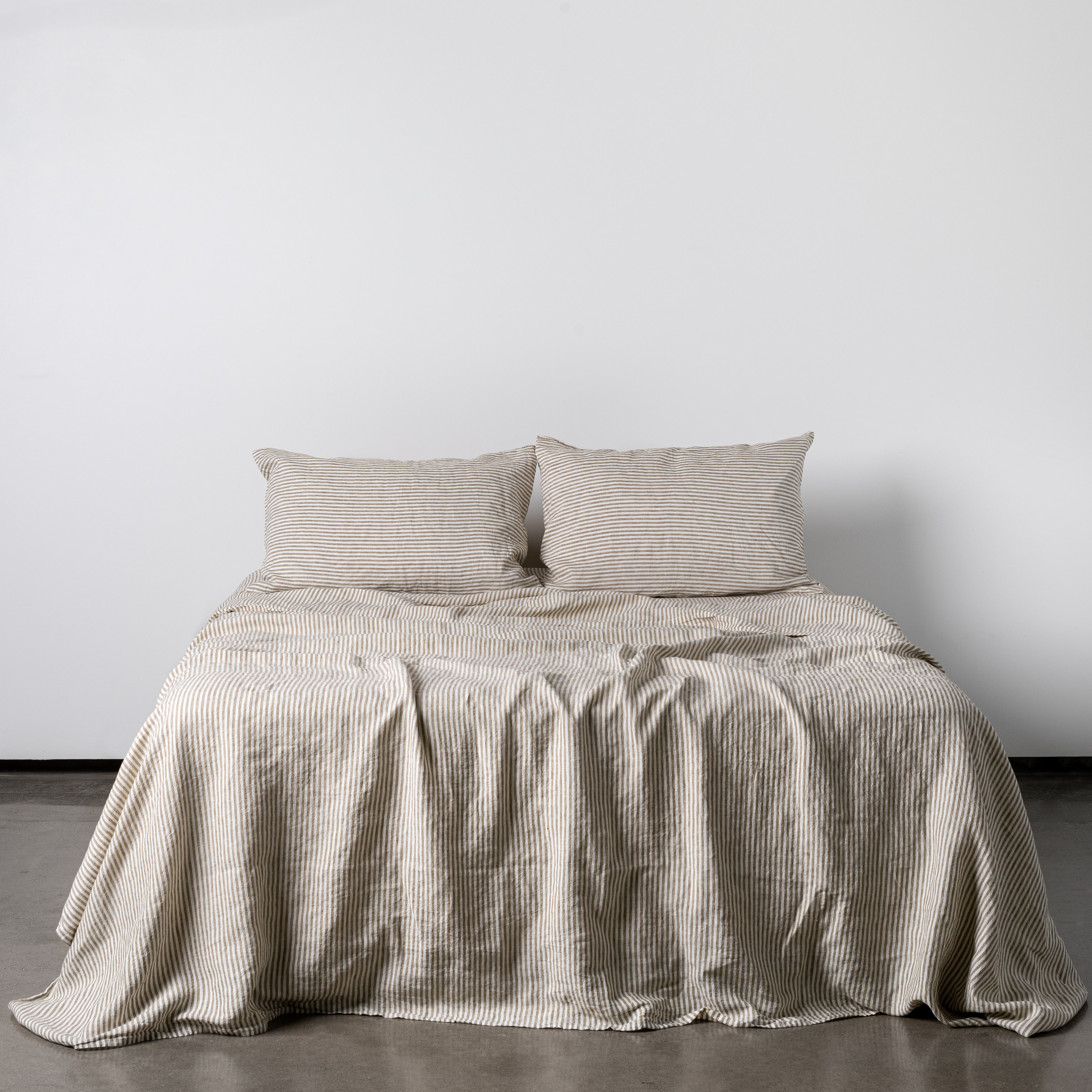 Foxtrot Home French Flax Linen styled in a bedroom with Olive Green Stripes Flat Sheet.