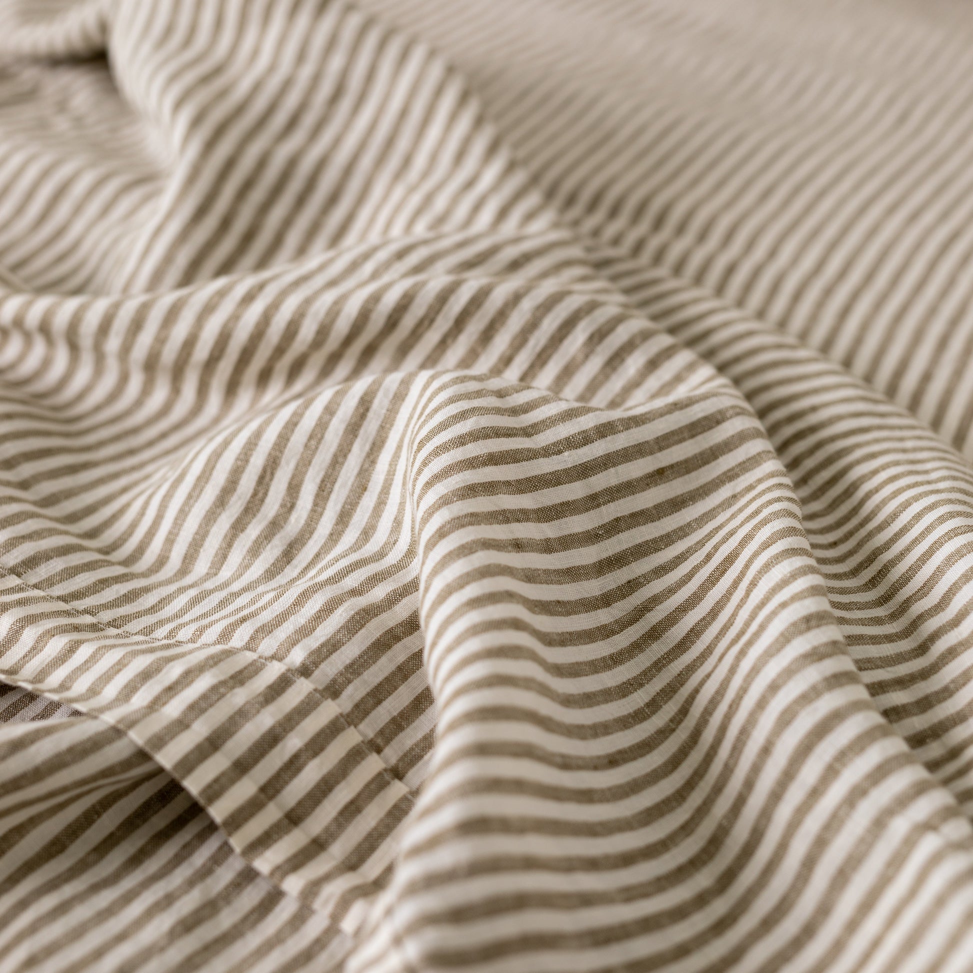 Foxtrot Home French Flax Linen styled in a bedroom with Olive Green Stripes Sheets Sets.