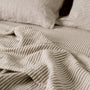 Foxtrot Home French Flax Linen styled in a bedroom with Olive Green Stripes Sheets Sets.