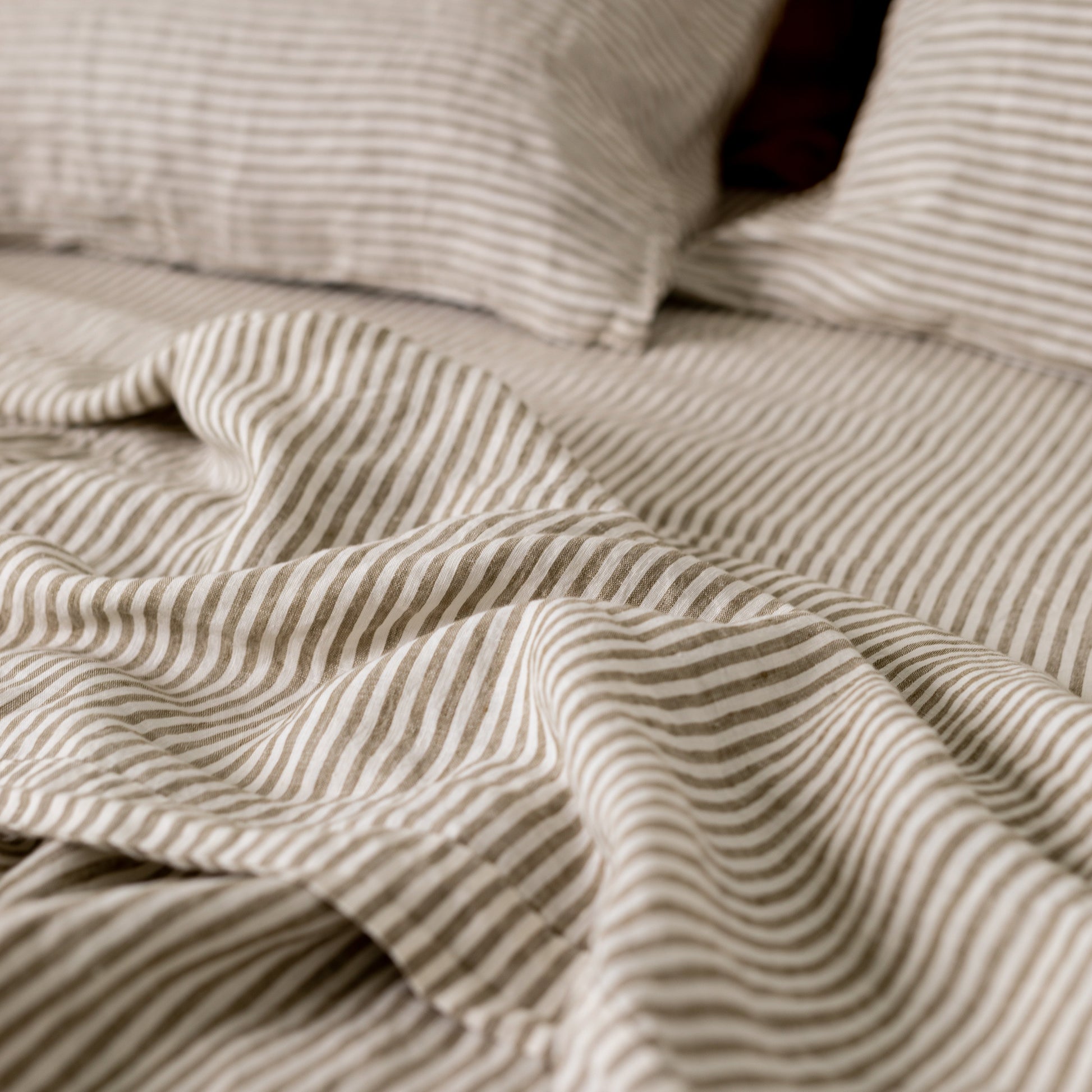 Foxtrot Home French Flax Linen styled in a bedroom with Olive Green Stripes Sheets Sets.