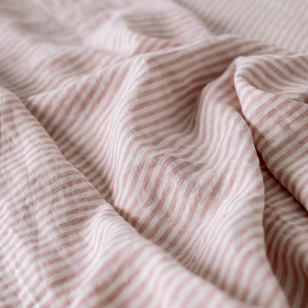 Foxtrot Home French Flax Linen styled in a bedroom with Pink Stripes Fitted Sheet.