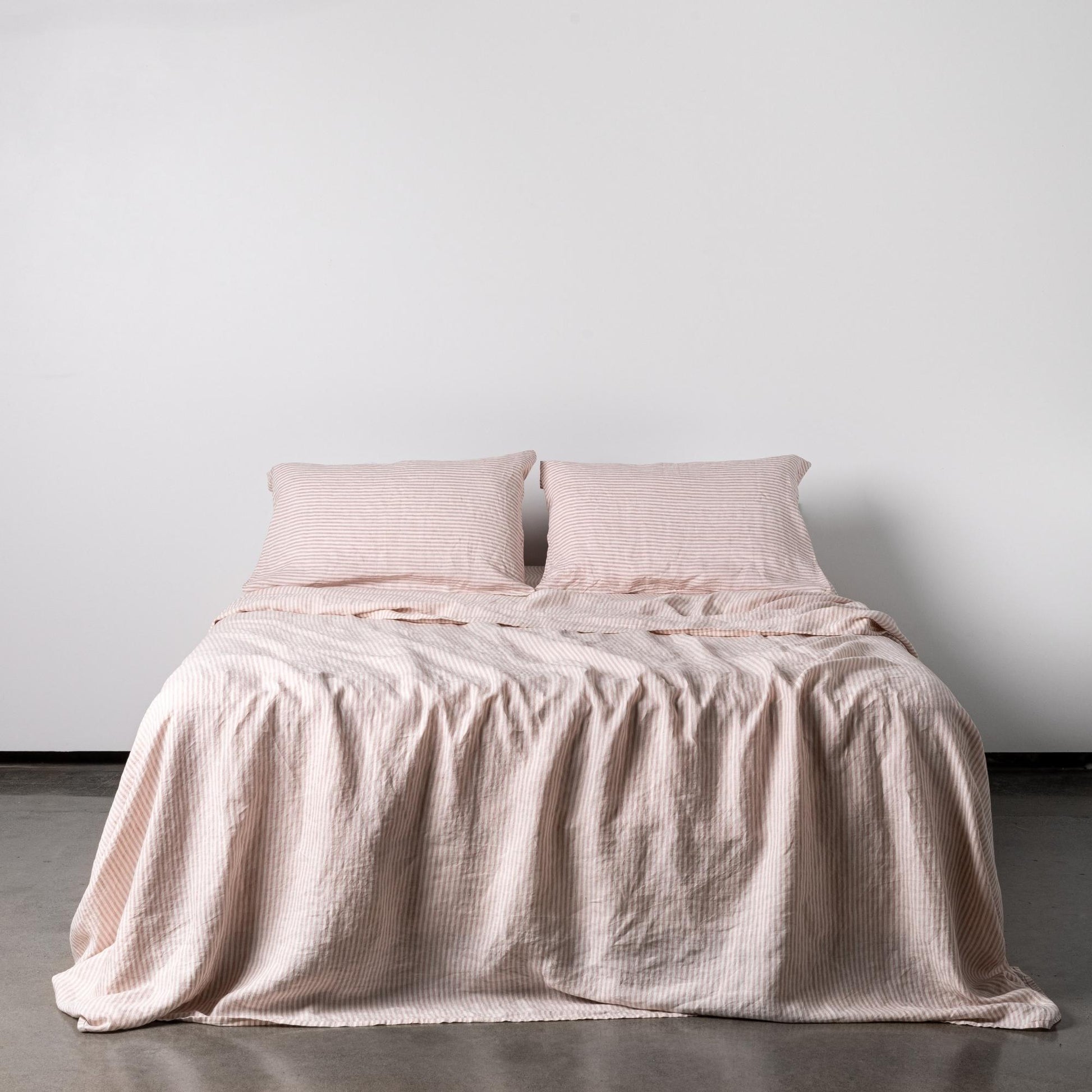 Foxtrot Home French Flax Linen styled in a bedroom with Pink Stripes Sheet Sheets.