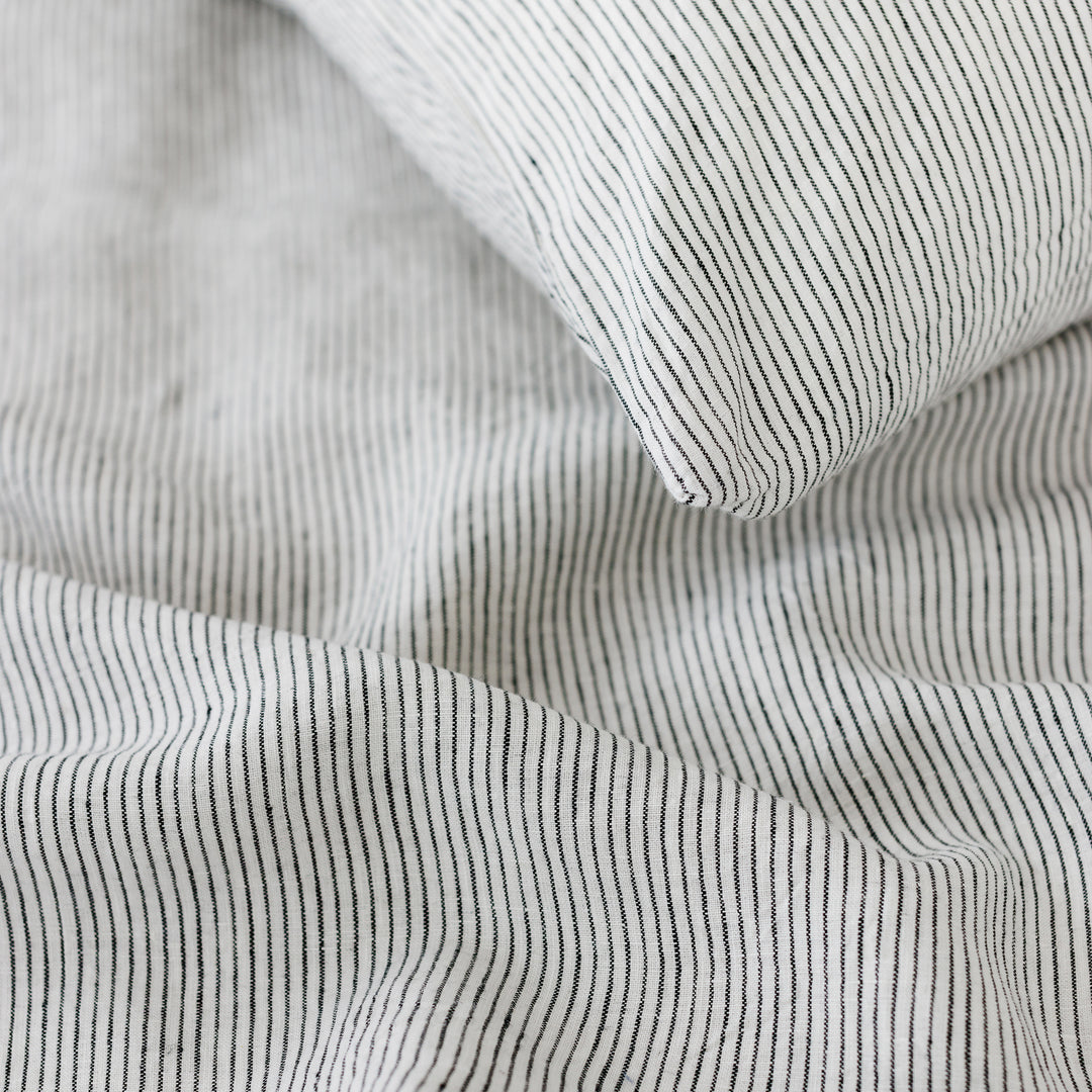 Foxtrot Home French Flax Linen styled in a bedroom with Pinstripes Cushion Cover.