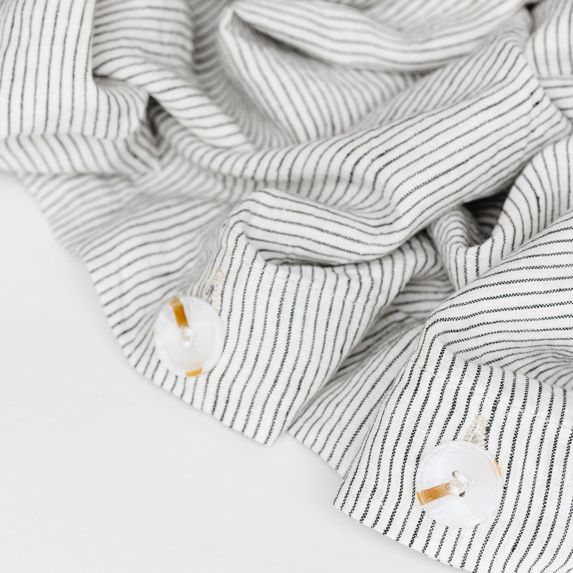 Foxtrot Home French Flax Linen styled in a bedroom with Pinstripes Duvet, Tobacco Sheets Set and Pillowcases.