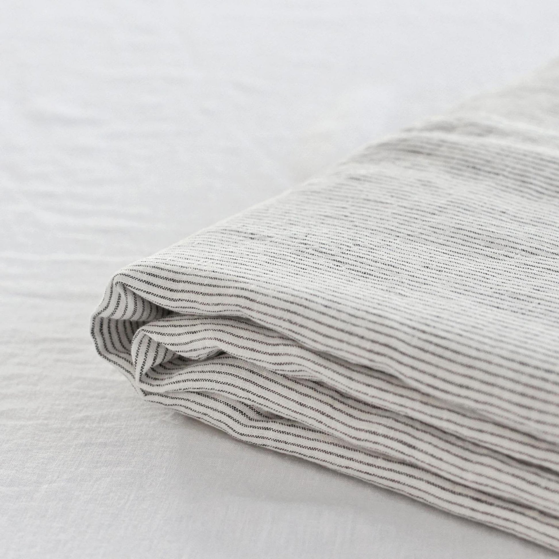 Foxtrot Home French Flax Linen styled in a bedroom with Pinstripe Sheets Sets.