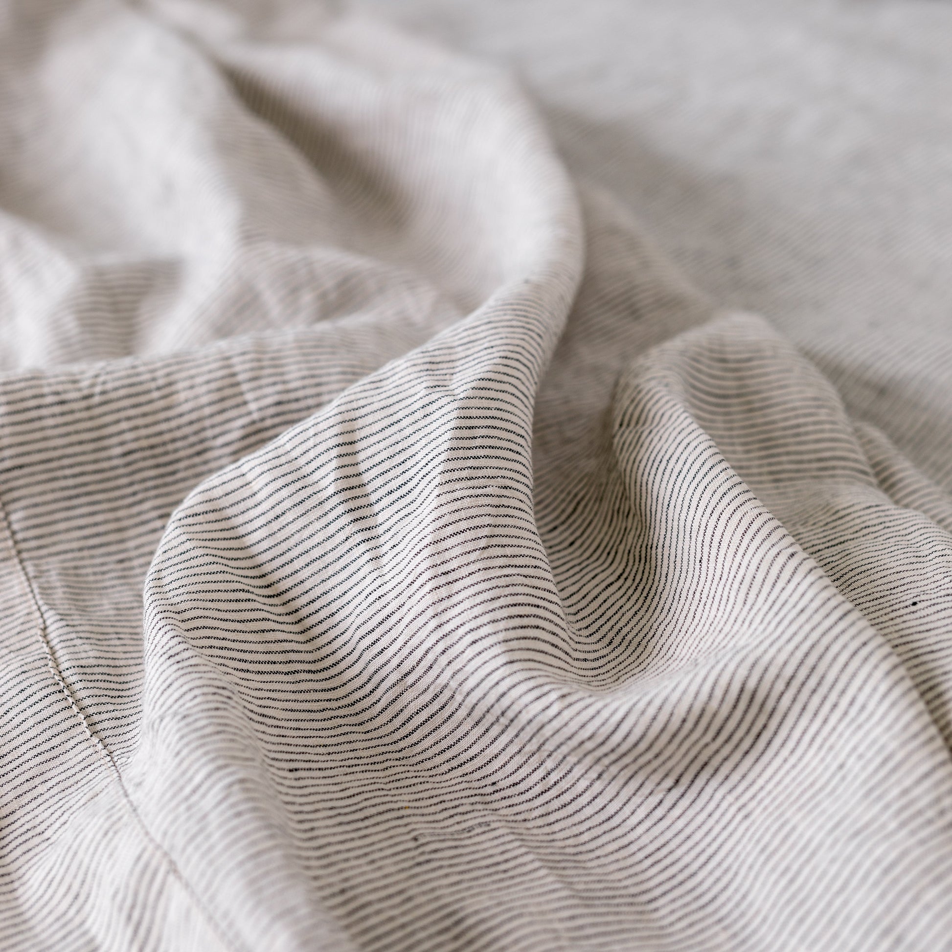 Foxtrot Home French Flax Linen styled in a bedroom with Pinstripe Sheets Sets.