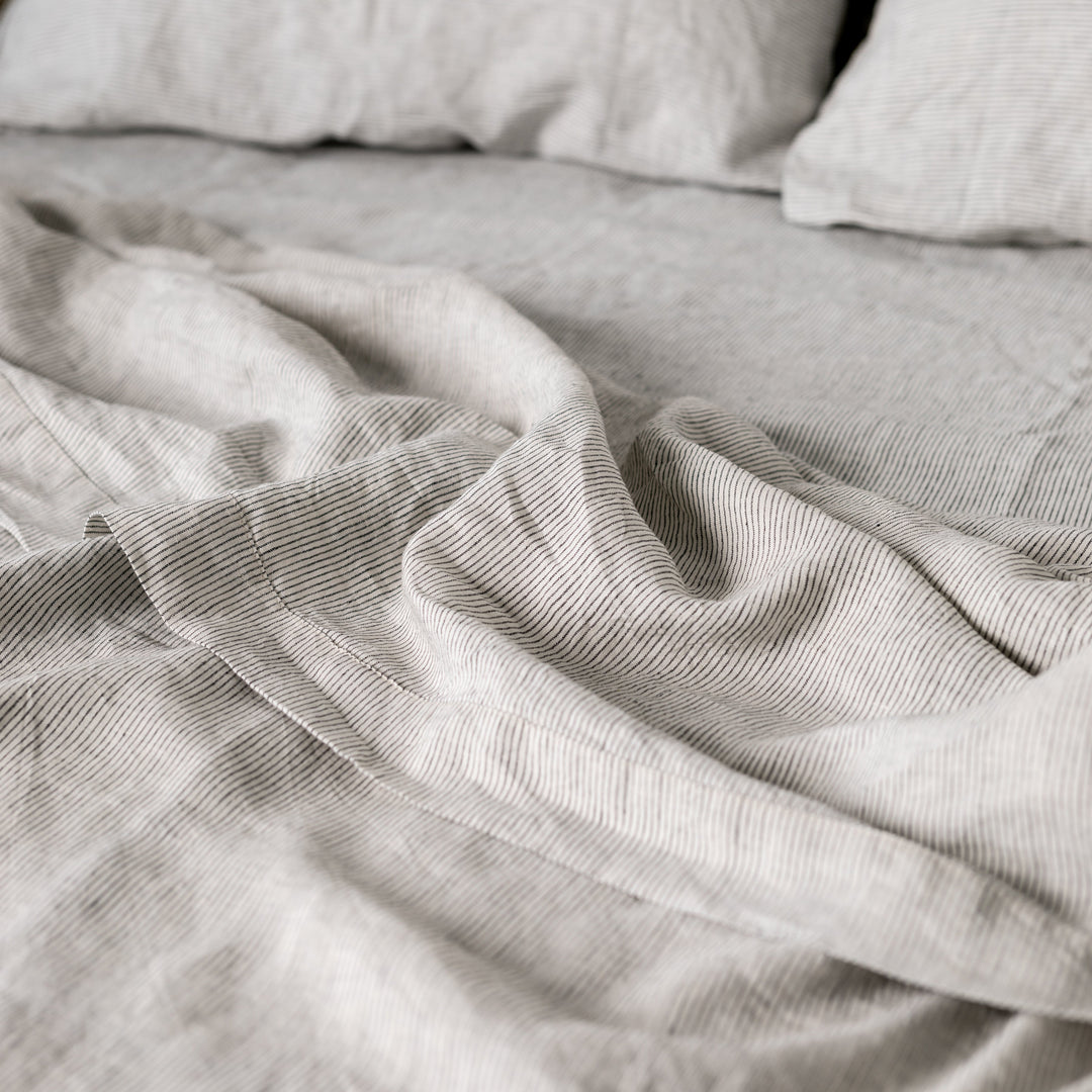 Foxtrot Home French Flax Linen styled in a bedroom with Pinstripe Sheets Sets.