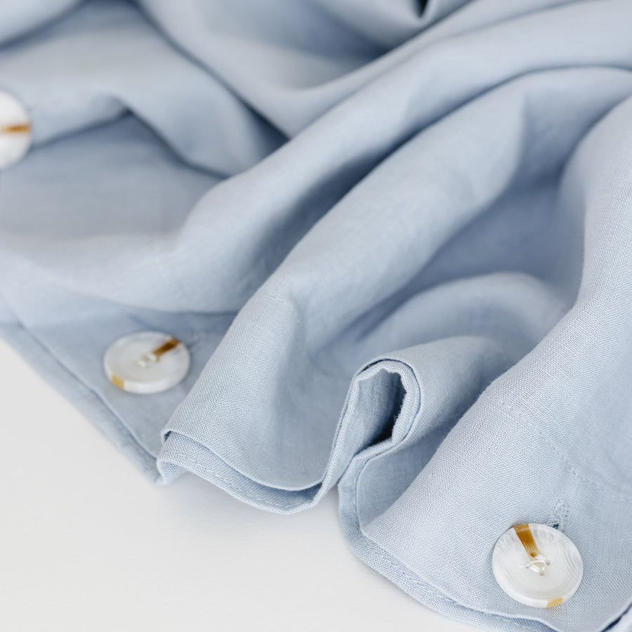 Foxtrot Home French Flax Linen styled in a bedroom with Powder Blue Duvet, Grey Stripes Sheets Sets and Pillowcases.