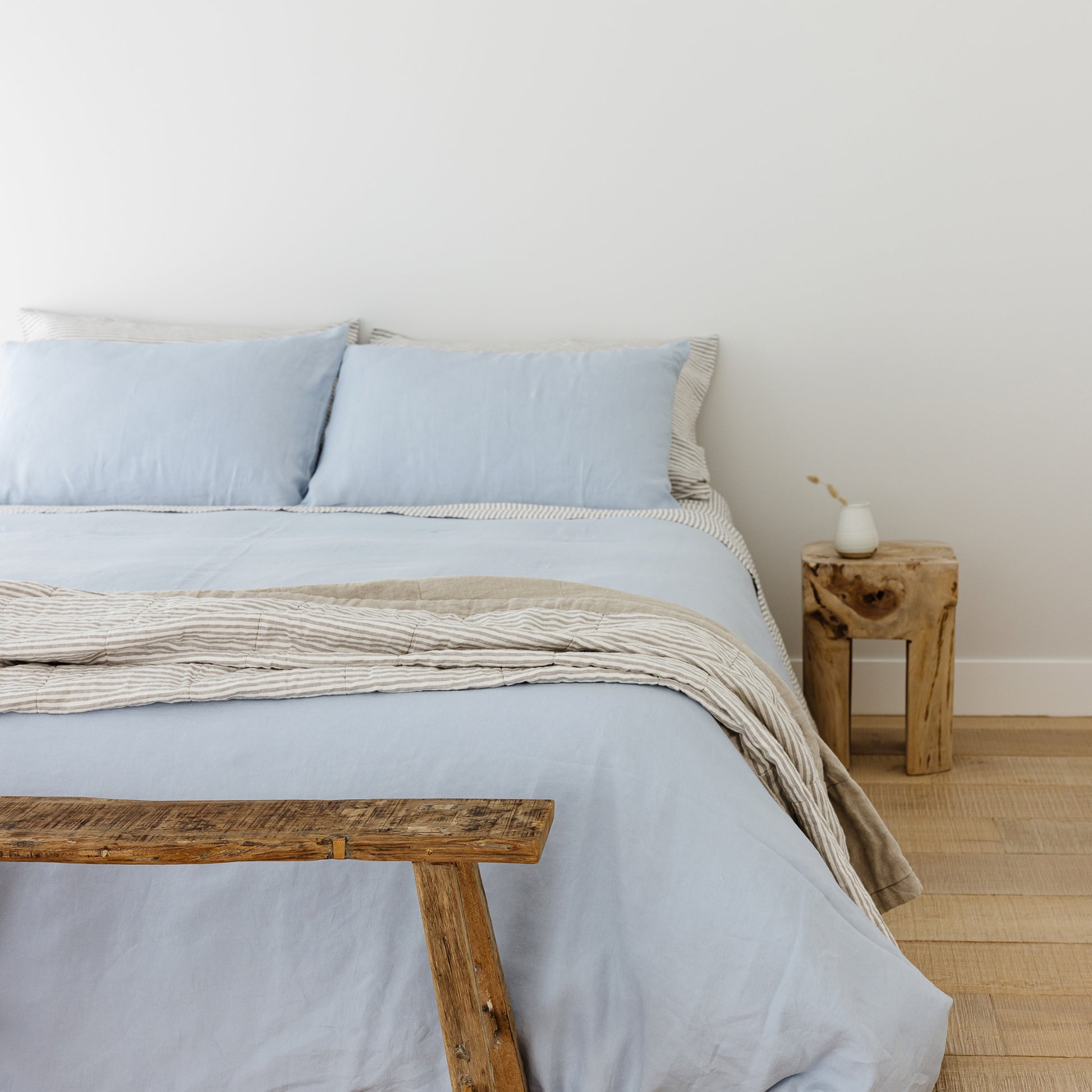 Foxtrot Home French Flax Linen styled in a bedroom with Powder Blue Duvet, Grey Stripes Sheets Sets and Pillowcases.