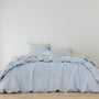 Foxtrot Home French Flax Linen styled in a bedroom with Powder Blue Duvet, Grey Stripes Sheets Sets and Pillowcases.